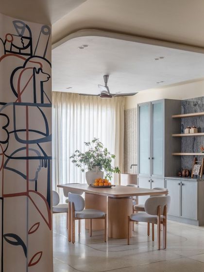 A minimalist line-art mural in a dining room, seen through a wooden partition. The artwork adds a subtle layer of narrative and elegance.