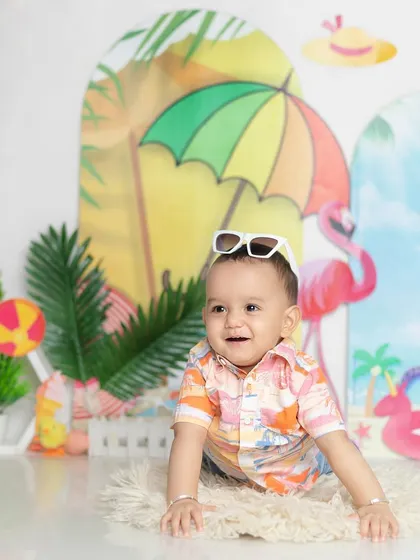 A cool dude with his sunglasses on. This playful shot adds so much personality to the beach theme.