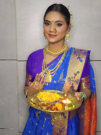 Holding a traditional puja thali, her makeup is perfect for the festive occasion of Gudi Padwa.