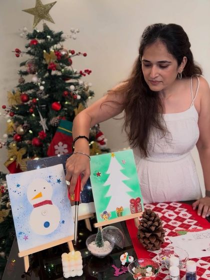 Here I am setting up for a Christmas painting party. I provide mini easels, canvases, and all the supplies needed for kids to paint their own snowman or Christmas tree masterpieces.
