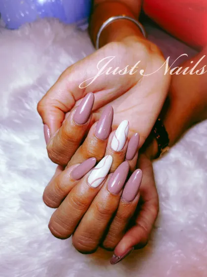 A chic and modern design with a dusty mauve base and abstract white line art on accent nails.