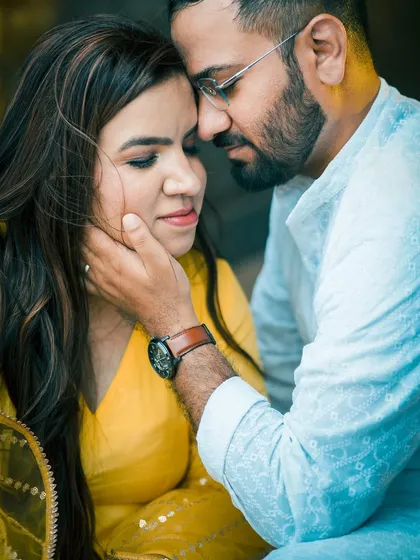 Another intimate close-up, this time focusing on the couple's expressions as they share a quiet moment. The natural lighting and soft focus add to the romantic feel.
