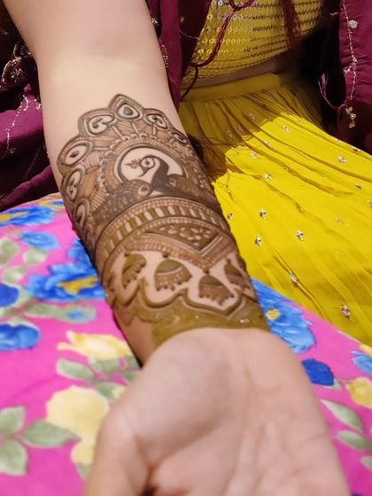 A close up of the beautiful arm band for bride Utsrini, featuring a peacock and jhumka design.