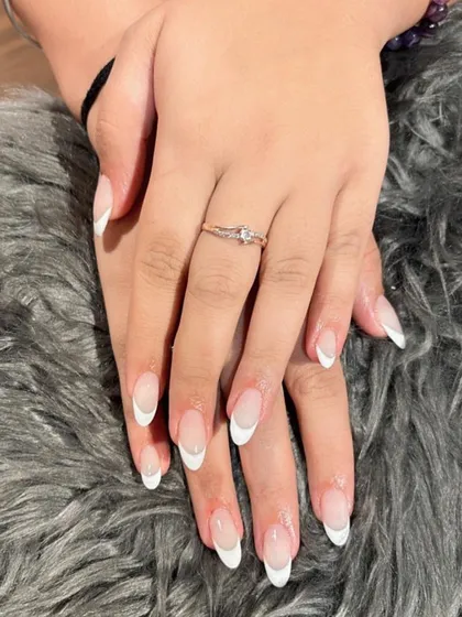 You can never go wrong with the classics. Here is a perfectly executed traditional white French manicure on elegant, almond-shaped nails.