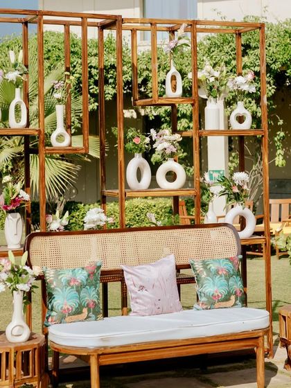 Another angle of the unique vase wall backdrop, showing how it serves as both a decor element and a piece of installation art within the event space.