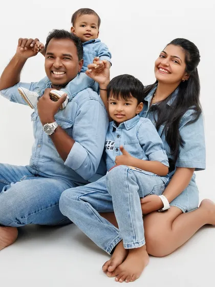 A playful family photo, with the youngest on his dad's shoulders. These are the fun, candid moments that families cherish.