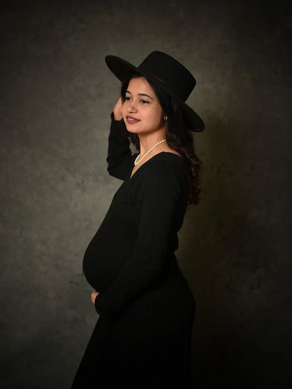 The same portrait without the digital frame, showing the clean and classic look of the original shot against a textured grey backdrop.