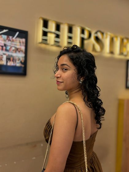 A side profile of a client's beautiful curly hair, styled to create drama, texture, and movement.