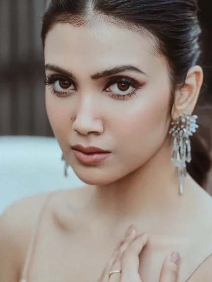 A beautiful close-up of actress Rajnandini Paul for a Sananda magazine shoot. The soft lighting highlights her delicate features and the sparkling earrings, creating an elegant and polished portrait.