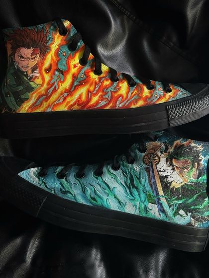 A pair of black Converse high-tops featuring intense, fiery artwork of Tanjiro from Demon Slayer.