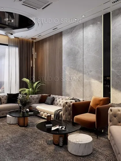 This drawing area in Bali Nagar, New Delhi, features tufted sofas, a dark color scheme, and a dramatic ceiling with recessed lighting, creating a cozy yet glamorous space.