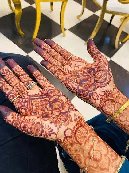 The final stain of a detailed floral design on both palms. My homemade organic henna paste develops into this rich, deep color, which photographs beautifully.