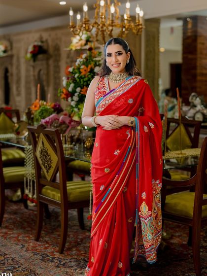 Wrapped in a classic red saree, this mama-to-be is glowing. The makeup is kept classic with a kohl-rimmed eye and flawless base.