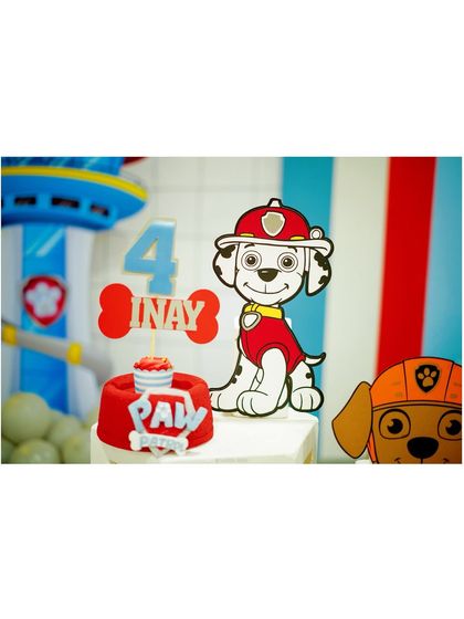 A close-up of the Paw Patrol cake topper, featuring Marshall and a personalized 'Inay 4' sign, showing our attention to the small, custom details.