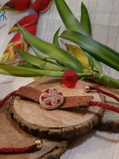 This handmade Rakhi is a work of art, combining traditional materials with a modern design. It's a beautiful symbol of the sibling bond.