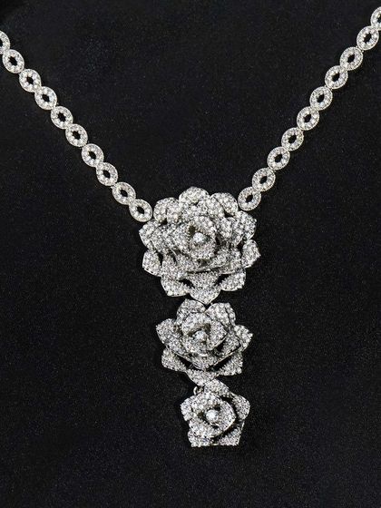 A clean, direct shot of a diamond floral necklace on a black background. This is a classic e-commerce image that clearly displays the entire product for online shoppers.