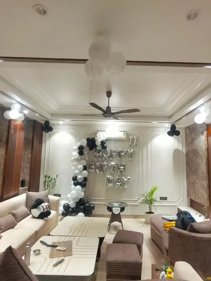 A wide view of the elegant black and white living room setup. This shows how our decorations can complement a modern home's interior design.