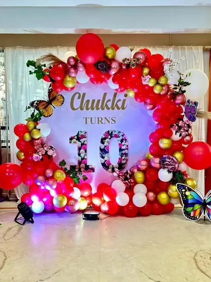 This butterfly theme for Chukki's 10th birthday uses a bold red balloon arch and floral details for a more dramatic and celebratory feel. Every theme is customized to the child's age and personality.