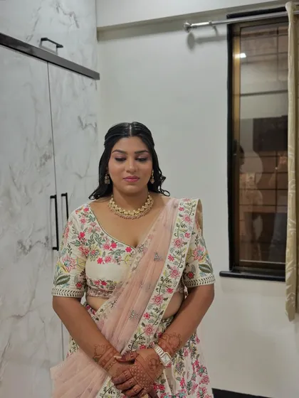 For her sister's engagement, she chose this beautiful floral lehenga. We styled her with a soft, natural makeup look.