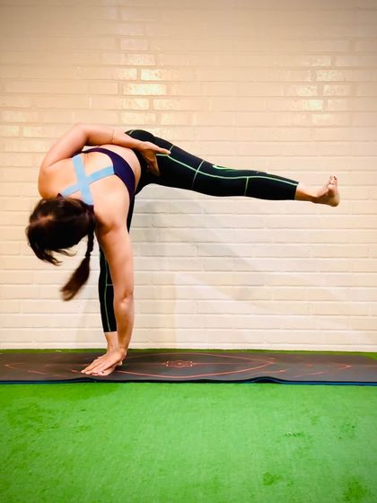 Ardha Chandrasana, or Half Moon Pose, with a bind. This balancing pose strengthens the entire body and teaches us to march into our wellness goals with focus and self-care.