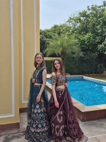 Our international clients looking elegant in our ethnic wear. They chose a deep teal lehenga and a rich wine-colored lehenga, both featuring beautiful traditional embroidery.