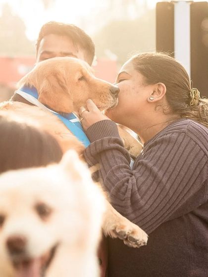 Another angle from the PetFed event, capturing a sweet kiss between a dog and its owner. These are the priceless, candid moments that pet parents cherish.