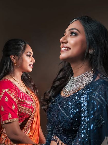 A beautiful portrait of the bride and her sister. Dr. Akshara's upward gaze and happy expression are beautifully captured, highlighting her reception makeup.