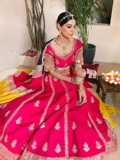 A modern princess bride in a vibrant pink lehenga. I created a subtle and elegant makeup look with defined eyes and a soft lip color to complement her stunning outfit.