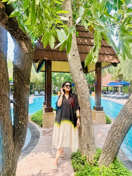 Another look at the wooden bangles, showing how they complement the relaxed, bohemian feel of the kaftan and the natural surroundings.