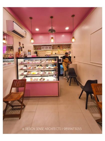 This shot shows the full interior from the entrance. Despite its narrow layout, the space feels bright and organized, with clear zones for display, service, and seating.