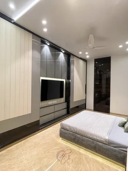 A perspective view showing the relationship between the bed and the sliding wardrobes. The design maximizes storage while maintaining a spacious and open feel.