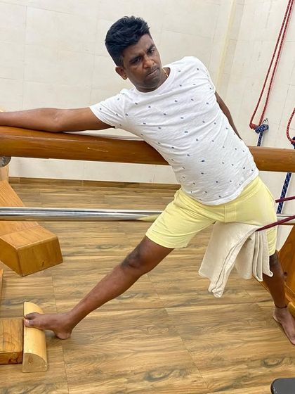 Using a specialized wooden horse prop to work on opening the hips and groin in a variation of Parsvakonasana. This prop is unique to Iyengar yoga studios.