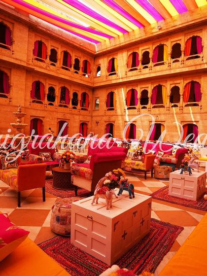 A wide shot of the vibrant Mehendi setup, with the central fountain adorned with flowers. This was a true feast for the eyes.