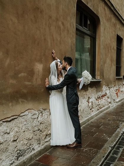 A passionate kiss in a quiet alley. This photo of Shahin and Michalina showcases the romance and intimacy of their wedding day in Poland.