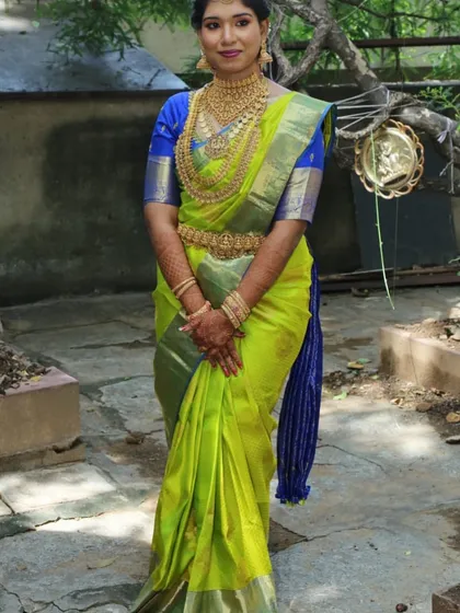 A happy client looking radiant on her special day. She is wearing one of our complete temple jewellery sets, featuring a kasu malai style necklace and matching vaddanam, proving you can achieve a grand look without the worry.