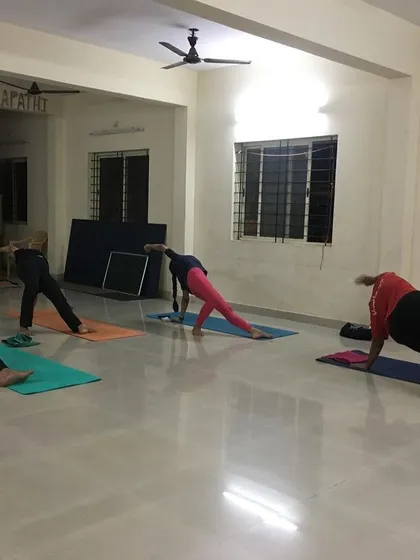A wider view of the studio during an arm-strengthening flow. You can see the focus and dedication of each student as they hold the pose.