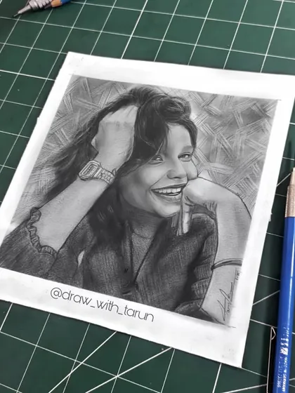 The finished graphite portrait on my work mat, giving a sense of scale and showing the tools used.