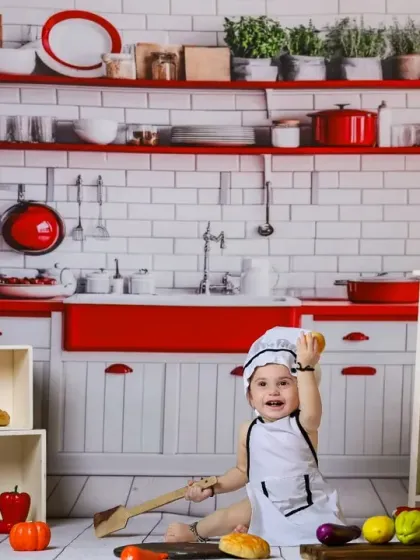 A happy chef surrounded by colorful toy fruits and vegetables. Our kitchen set is a feast for the eyes.