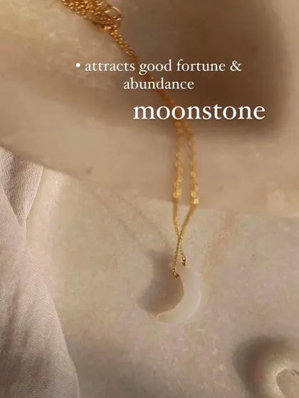 The white moonstone Luna pendant, a charm that attracts good fortune and abundance. Its soft glow is a reminder of the moon's quiet power.