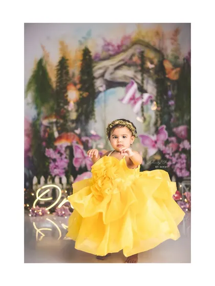A beautiful little fairy in a bright yellow dress, exploring her enchanted forest.