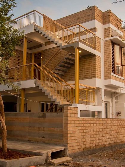 This building showcases Harmony. The repetition of the earth block material, the consistent color of the railings, and the rhythm of the staircase create a sense of unity across the entire structure.