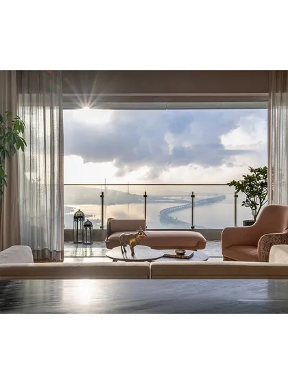 This living room in Mumbai was designed to capture the breathtaking panoramic view of the city's skyline and the sea. The interior palette is kept soft and luxurious to complement, not compete with, the view, creating a tranquil sanctuary high above the bustling city.