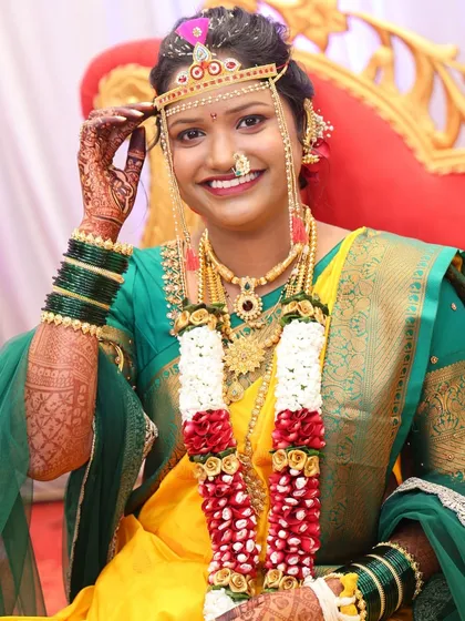 My bride looking radiant and happy, adorned with garlands and traditional wedding attire.