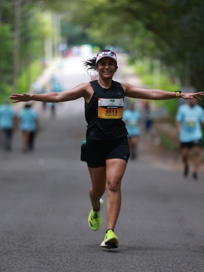 Flying towards the finish line at the Mysuru Half Marathon. This feeling of freedom and strength is what we train for.