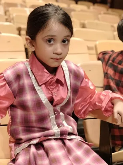 A young actress waiting patiently for her cue. The discipline of waiting quietly backstage is an important part of theatre etiquette.