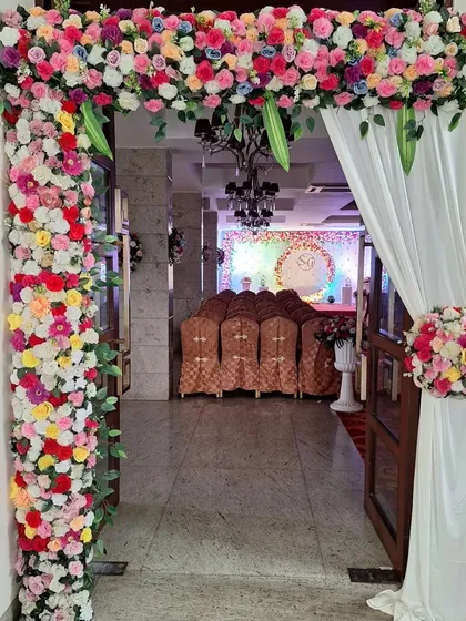 An elegant floral archway designed for the entrance of an engagement party venue. This welcoming decor sets the tone for the event and provides a beautiful photo opportunity for guests as they arrive.