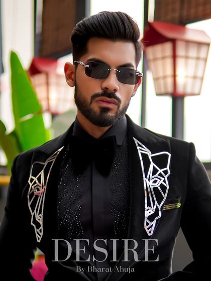 A powerful portrait in the black velvet tuxedo. The geometric embroidery on the lapels adds a unique, artistic touch to a classic piece.