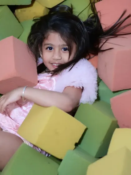 A young guest having a blast in our foam block pit. It's another safe and fun sensory activity area for kids to explore.