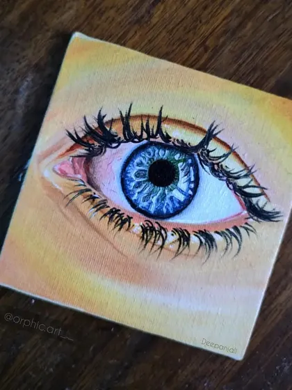 A miniature oil painting of a blue eye on a small square canvas. I focused on the details of the iris and the reflection in the pupil, making it look like an ocean.