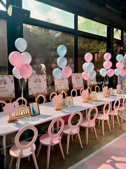 Themed seating for the little royals, with custom-designed chairs and activity station signs for face painting and hair styling.